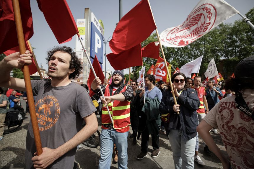 Protesters waving flags during a rally marking International Labor Day in Toulouse, southwestern France, on May 1.