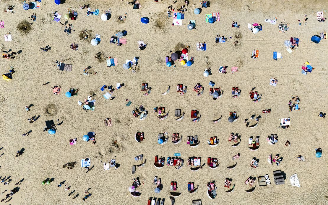 Flight analytics firm Cirium has observed a sharp drop in summer bookings to popular destinations in Europe. Here, people sunbathe on the beach at a seaside resort west of Amsterdam.