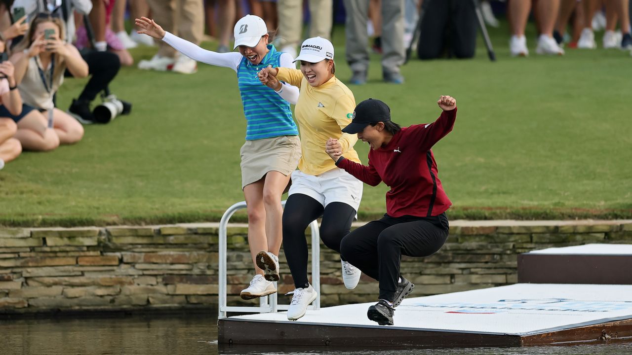 THE WOODLANDS, TEXAS - APRIL 27: Mao Saigo of Japan (C) jumps in the pond on the 18th hole after winning The Chevron Championship 2025 in a playoff at The Club at Carlton Woods on April 27, 2025 in The Woodlands, Texas. (Photo by Alex Slitz/Getty Images)