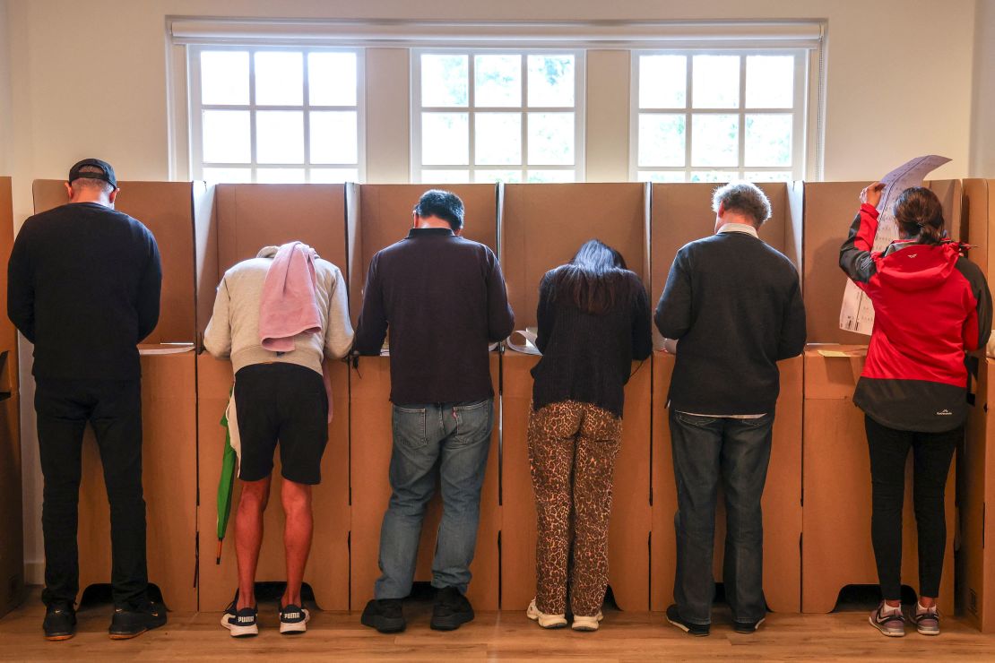 Voters mark their ballot papers at a pre-polling center in Sydney on Friday.