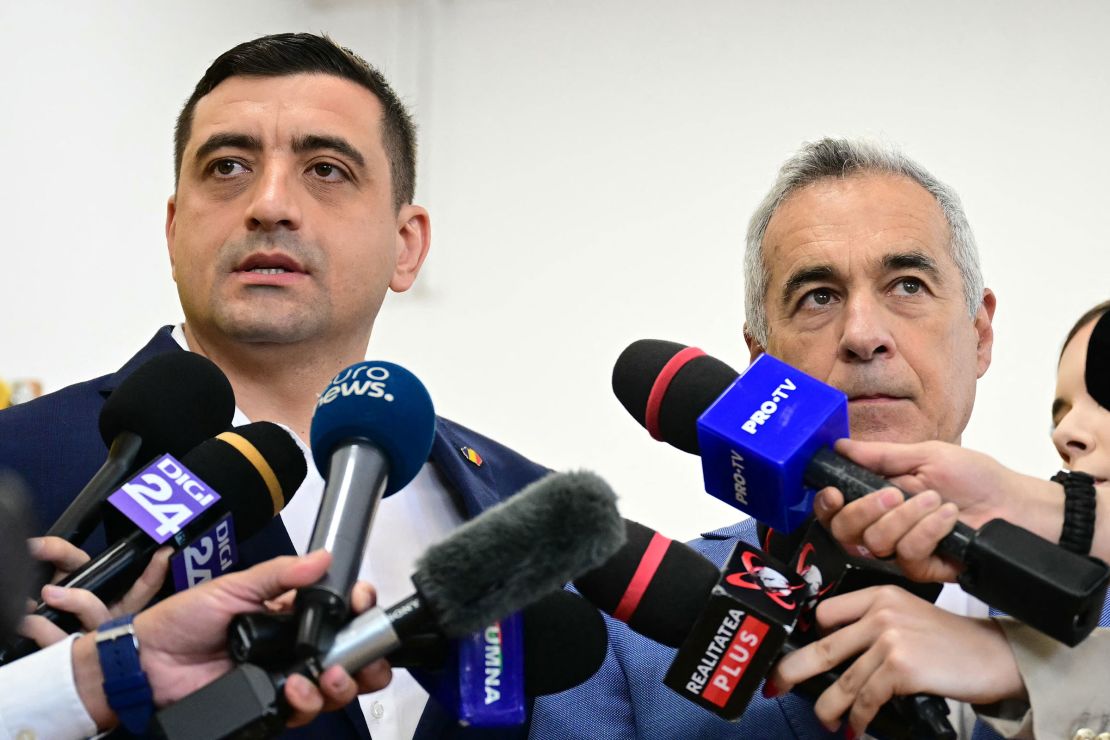Leader of the Alliance for the Union of Romanians party George Simion, left, and former candidate Calin Georgescu address journalists after casting their ballots.