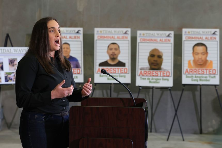 Deputy Director, US Immigration and Customs Enforcement Madison Sheahan speaks during a press conference, in front of posters of people that law enforcement arrested, held at the ICE-Enforcement and Removal Operation office on May 1, in Miramar, Florida.