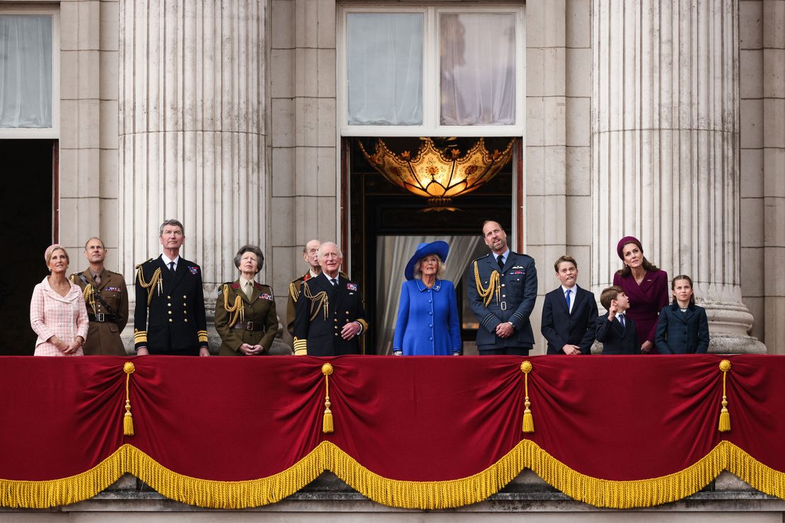 The royal family watches as the Red Arrows soar over Buckingham Palace.