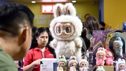 People look at collectable designer art toy Labubu at a Pop Mart pop-up store in Siam Center shopping mall in Bangkok on May 6, 2025. (Photo by Lillian SUWANRUMPHA / AFP) (Photo by LILLIAN SUWANRUMPHA/AFP via Getty Images)          
