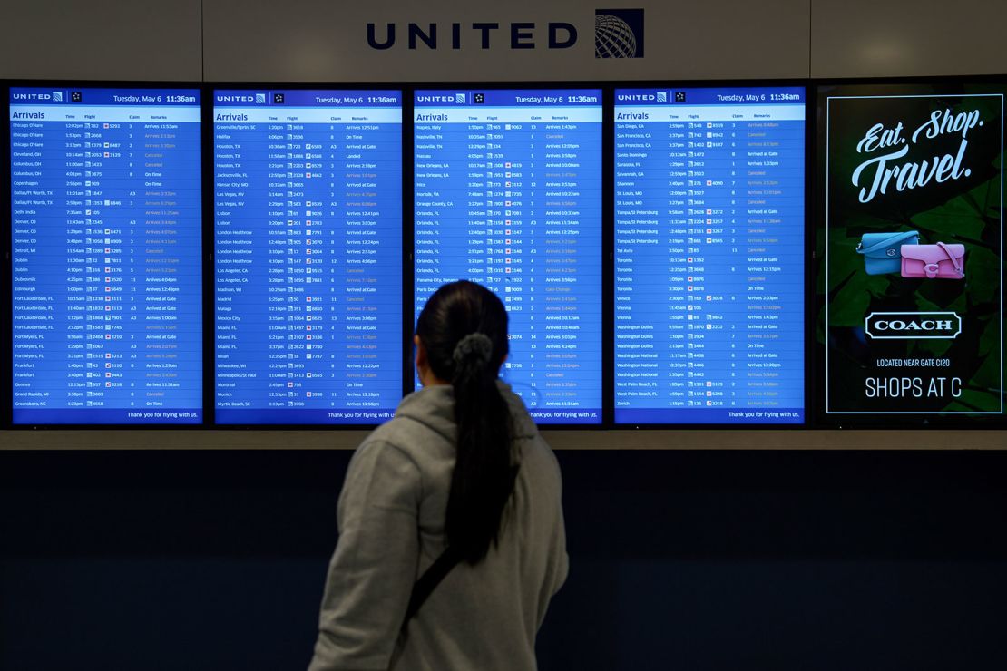 A passenger watches the arrivals board at Newark Liberty International Airport on Tuesday.