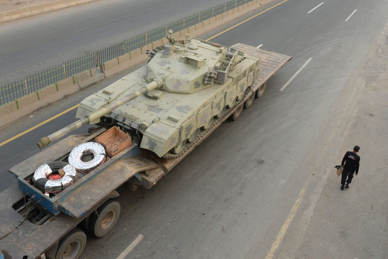 A truck transports an army tank on a road in Muridke, Pakistan, on Wednesday.