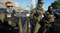 Immigration and Customs Enforcement (ICE) agents stand near a gate at Delaney Hall, a newly converted immigrant detention centre in Elizabeth, New Jersey May 7, 2025. Delaney Hall has the ability to hold over a 1000 people, and the detention facility, privately owned by The GEO Group, holds a contract with the federal government to house people arrested by ICE. (Photo by TIMOTHY A. CLARY / AFP) (Photo by TIMOTHY A. CLARY/AFP via Getty Images)