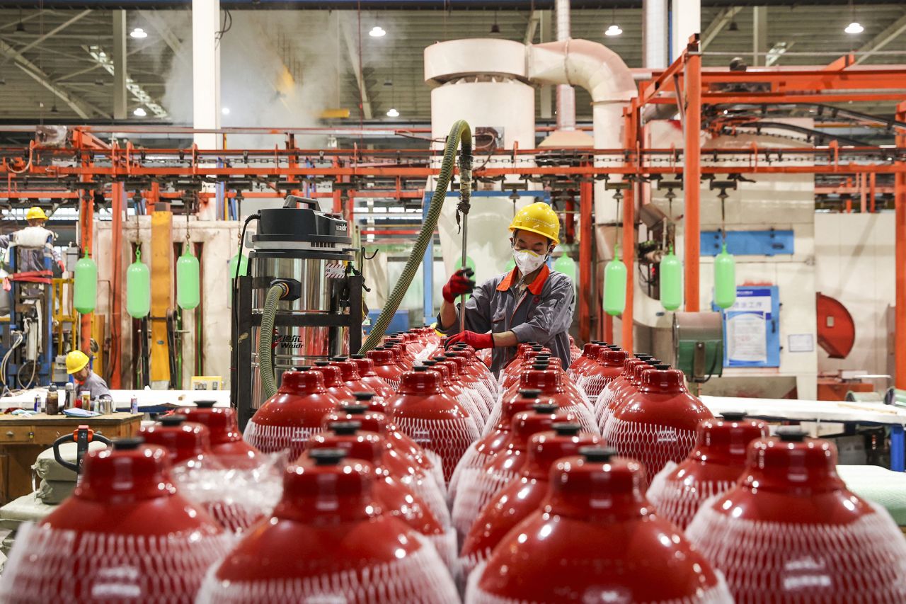 An employee produces automobile gas cylinders for export at a factory in Ruichang, in eastern China's Jiangxi province on May 8.