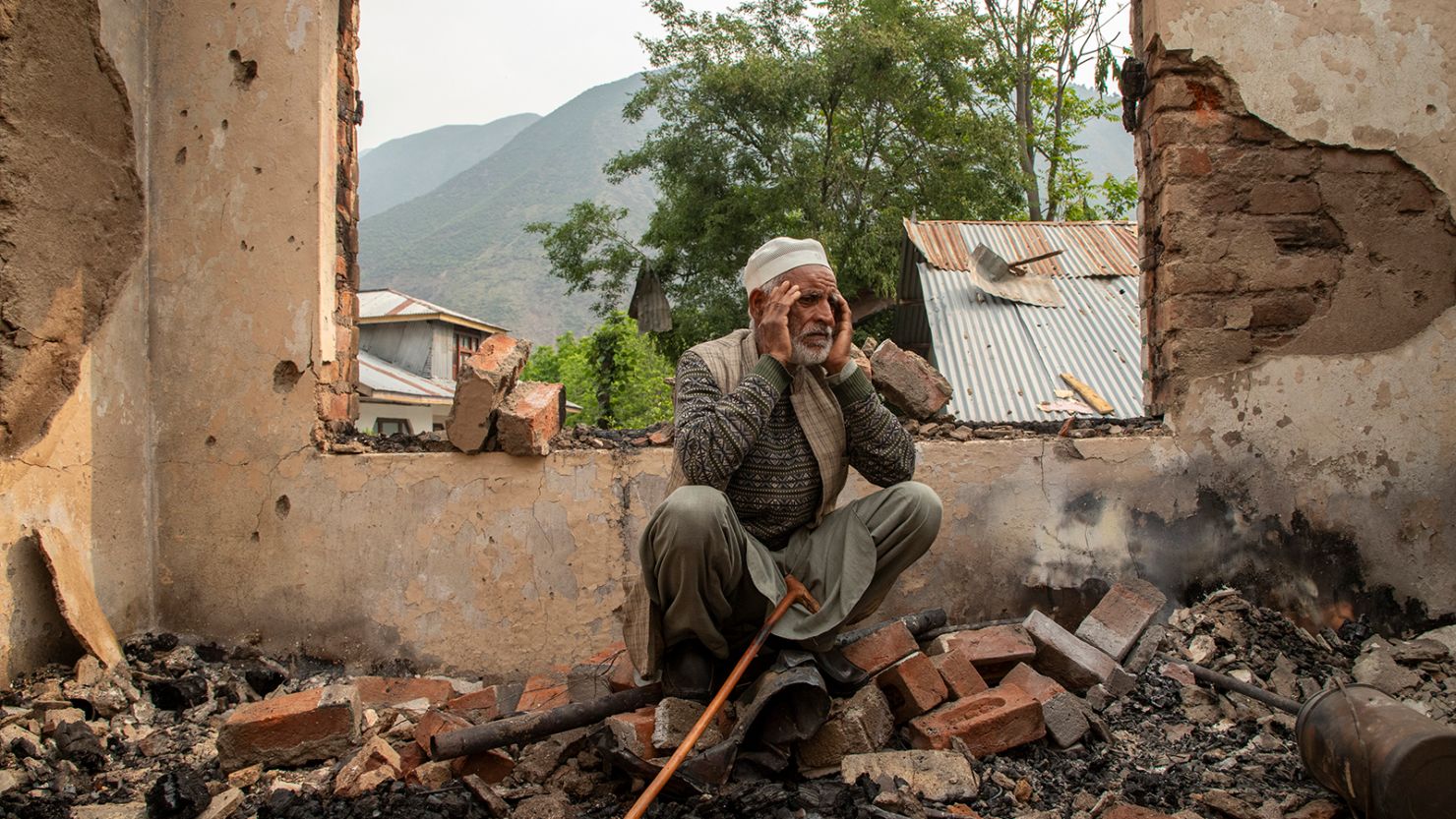A Kashmir resident looks at his damaged home in Salamabad, near the Line of Control, in India-administered Kashmir on May 8, 2025.