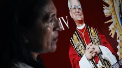 TOPSHOT - A woman stands next to the image of Robert Francis Prevost, who became Pope Leo XIV on May 8, 2025, in front of the cathedral of Chiclayo in northern Peru on the day of his election as the Catholic Church's 267th pontiff. The US-born pontiff, close to Pope Francis, became a Peruvian national in 2015 and devoted more than 20 years as a missionary in Peru. (Photo by ERNESTO BENAVIDES / AFP) (Photo by ERNESTO BENAVIDES/AFP via Getty Images)