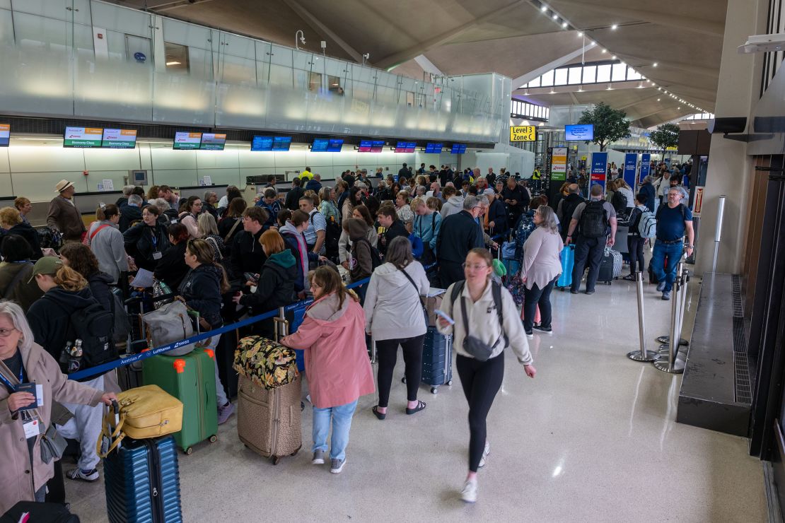 Passengers wait in line for a delayed flight at Newark airport on Monday, amid rolling delays and cancellations at the airport.