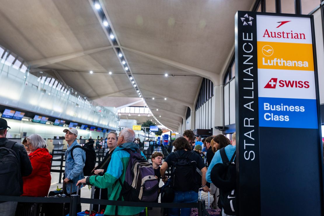 People wait in line for a delayed flight at Newark Liberty International Airport on Monday.