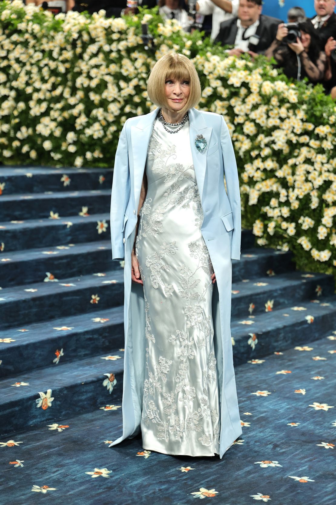 Anna Wintour, editor-in-chief of Vogue, wears a floor-length baby blue coat designed by Pharrell for Louis Vuitton.
