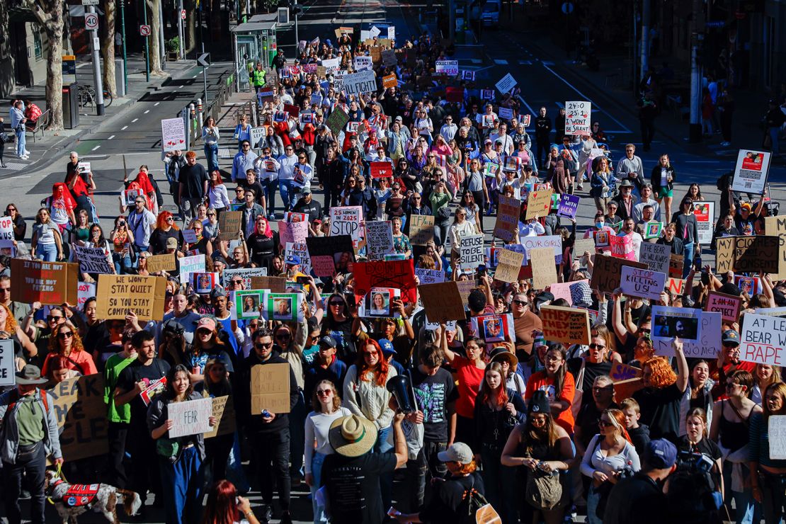 Protesters march with placards toward Parliament during the women's rights rally in Melbourne, Australia on May 10, 2025.
