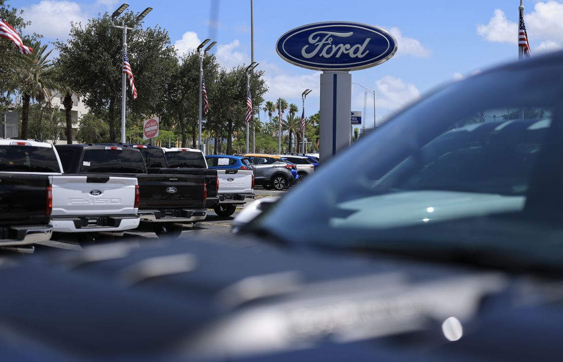 Ford vehicles sit on the Metro Ford sales lot on May 6 in Miami. Ford Motor Co. pulled its 2025 guidance and said it expects a tariff hit of about $1.5 billion for the year as US automakers face economic uncertainty.