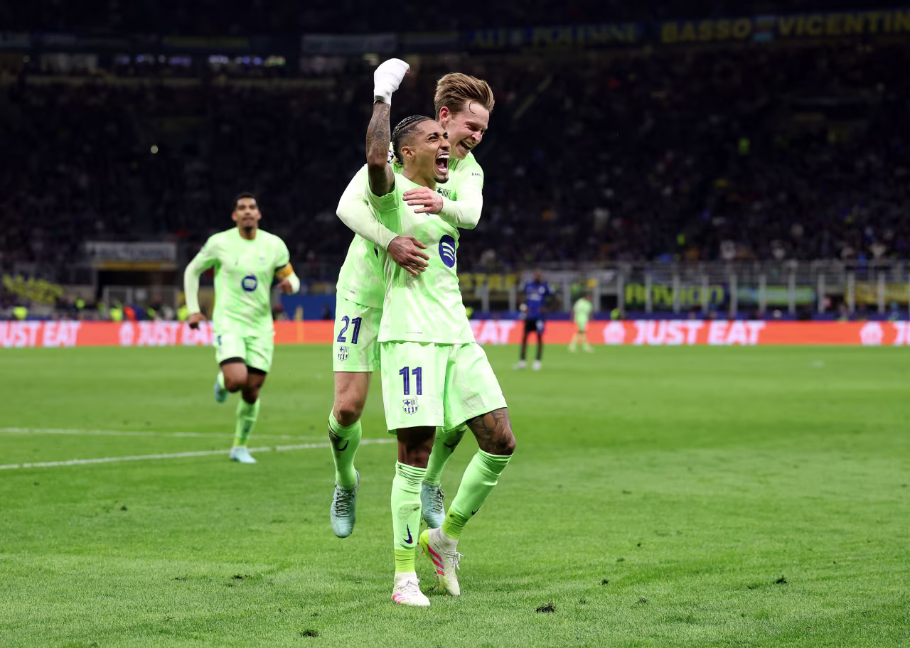 Barcelona's Raphinha celebrates scoring his team's third goal with teammate Frenkie de Jong.