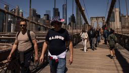 Tourists on the Brooklyn Bridge in New York, US, on Saturday, May 10, 2025. New York City officials cut their forecast for the number of international tourists this year by 17%, saying President Donald Trump's tariffs and hard-line policies on immigration are deterring visitors. Photographer: Yuki Iwamura/Bloomberg via Getty Images