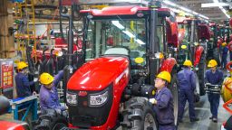 Employees work on the tractor assembly line at a YTO Group Corporation factory in Luoyang, Henan Province of China, on May 6.
