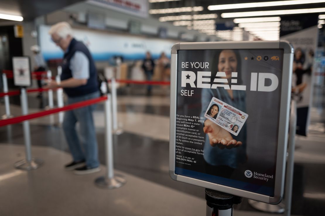A sign notifies passengers at a security checkpoint about Real ID requirements for travel at O'Hare International Airport on May 7.