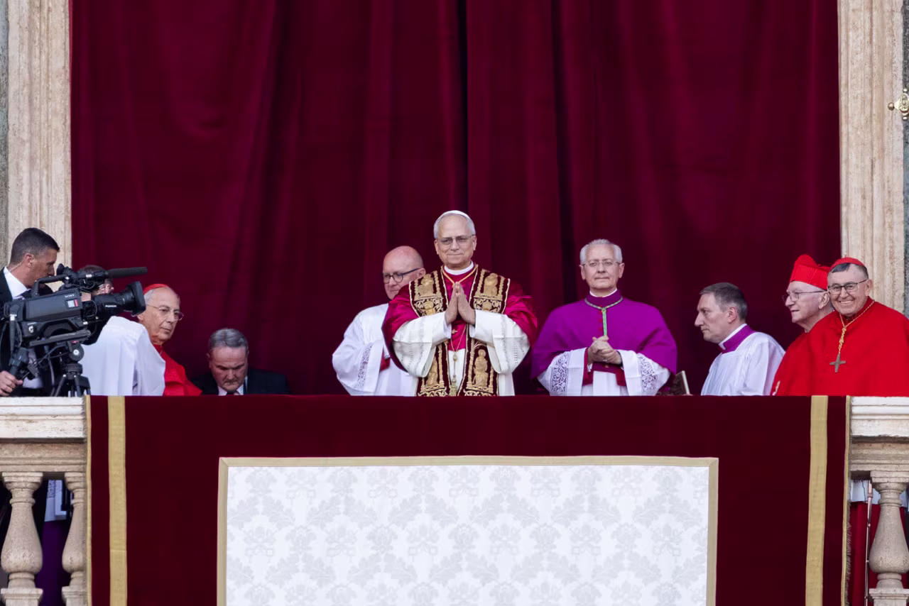 Cardinals gather with the newly elected Pontiff, Pope Leo on the Vatican balcony on Thursday.