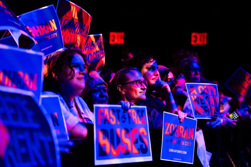 Supporters hold signs calling for free buses and affordable housing during a rally in support of Zohran Mamdani in the Brooklyn borough of New York, on May 4.