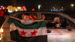 TOPSHOT - People celebrate in Damascus' Omeyyad square after US President Donald Trump's decision to lift sanctions in Syria, on May 13, 2025. (Photo by Abdulaziz KETAZ / AFP) (Photo by ABDULAZIZ KETAZ/AFP via Getty Images)