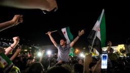 People celebrate in Umayyad Square in Damascus, Syria, on May 13, following US President Donald Trump's decision to lift sanctions in Syria.