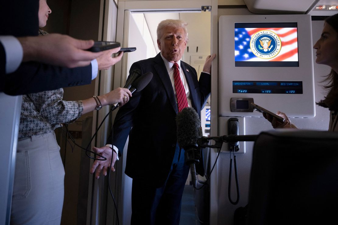US President Donald Trump speaks to members of the press on Air Force One while flying over Saudi Arabia on his way to Qatar on Wednesday.