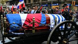 People applaud as the carriage carrying the remains of the late Uruguay's former president (2010-2015) Jose 'Pepe' Mujica moves forward during the funeral cortege in Montevideo, on May 14, 2025. Mujica, an ex-guerrilla fighter and hero of the Latin American left, died on May 13, 2025 at the age of 89. The humble leader -- who once spent a dozen years behind bars for revolutionary activity -- lost his battle against cancer after announcing in January the disease had spread and he would stop treatment. (Photo by Pablo PORCIUNCULA / AFP) (Photo by PABLO PORCIUNCULA/AFP via Getty Images)          