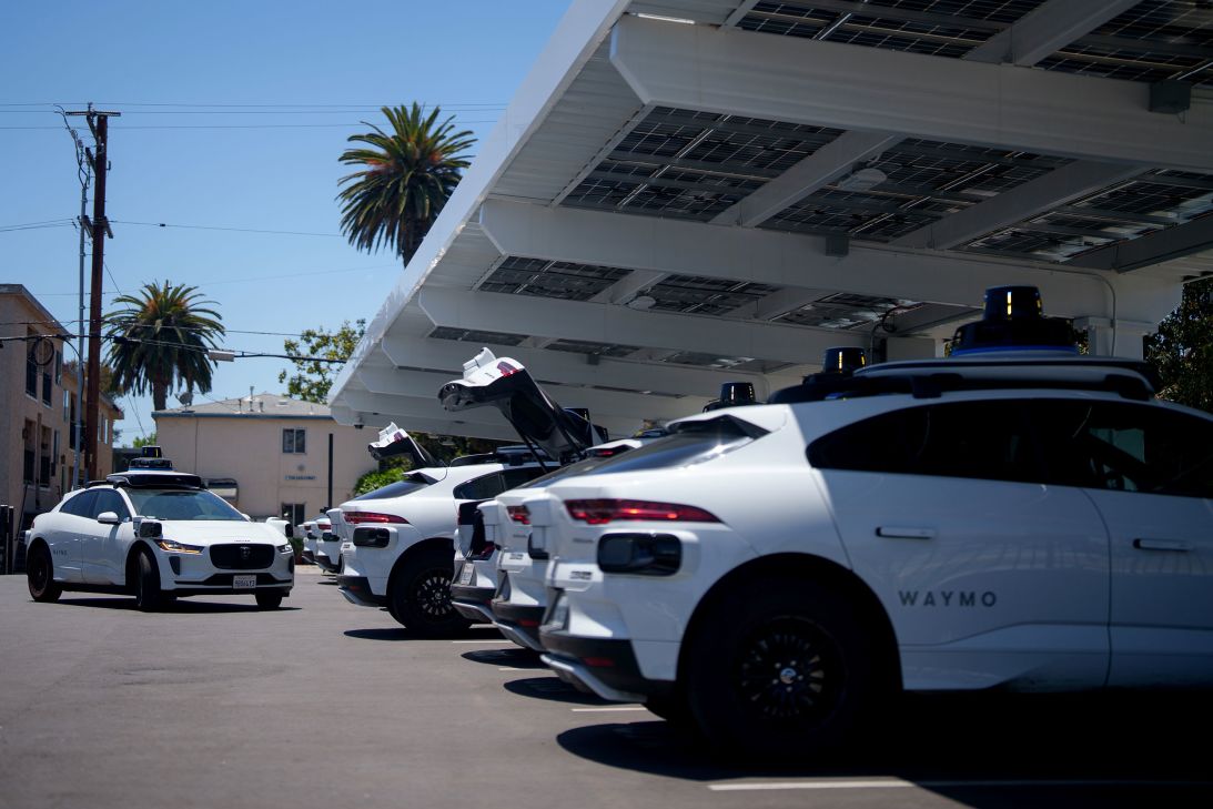 Waymo vehicles charge at a lot in Santa Monica in May.