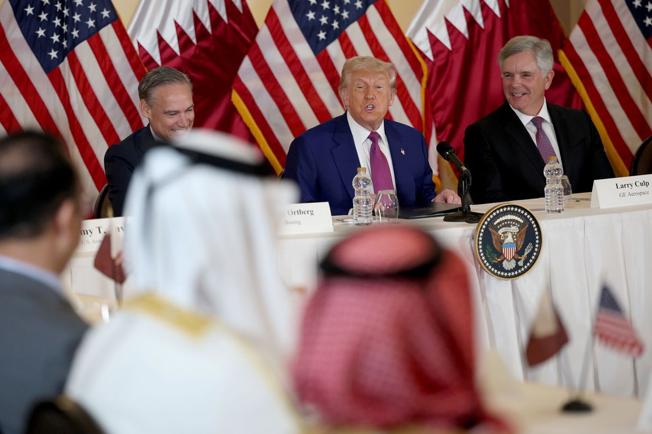 President Donald Trump, flanked by chairman and CEO of GE Aerospace Larry Culp, right, and CEO of Boeing Kelly Ortberg, meets with business leaders at the Ritz Carlton Hotel in Doha, Qatar, on Thursday.