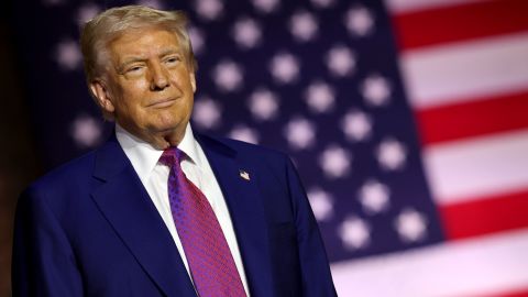 DOHA, QATAR - MAY 15: U.S. President Donald J. Trump stands on stage as he tours the Al Udeid Air Base on May 15, 2025, in Doha, Qatar. Trump is on the third day of his visit to the Gulf to underscore the strategic partnership between the United States and Qatar, focusing on regional security and economic collaboration.  (Photo by Win McNamee/Getty Images)