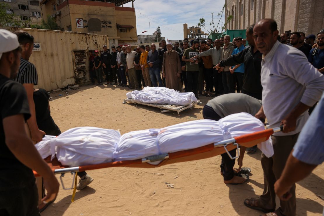 The shrouded bodies of victims of Israeli strikes on Jabalya, are placed on the grounds of the Indonesian hospital in Beit Lahia, in the northern Gaza Strip on May 15, 2025.