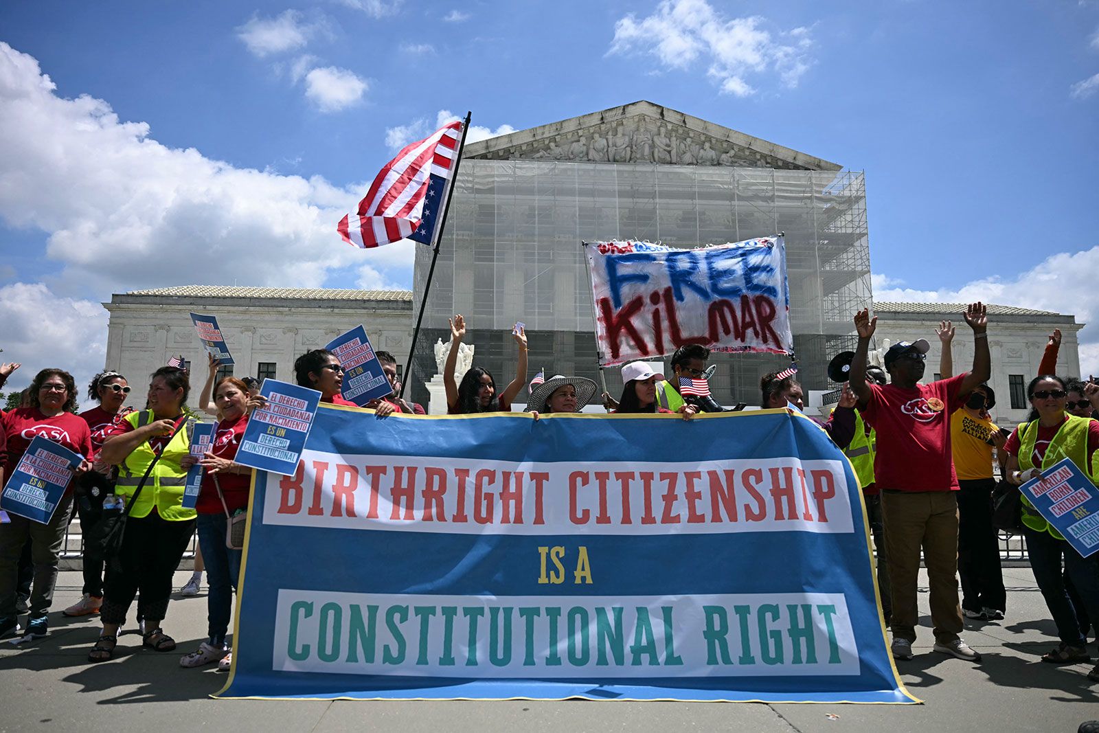 People hold a banner as they participate in a protest outside the US Supreme Court over President Donald Trump's move to end birthright citizenship as the court hears arguments over the order in Washington, DC, on May 15, 2025.