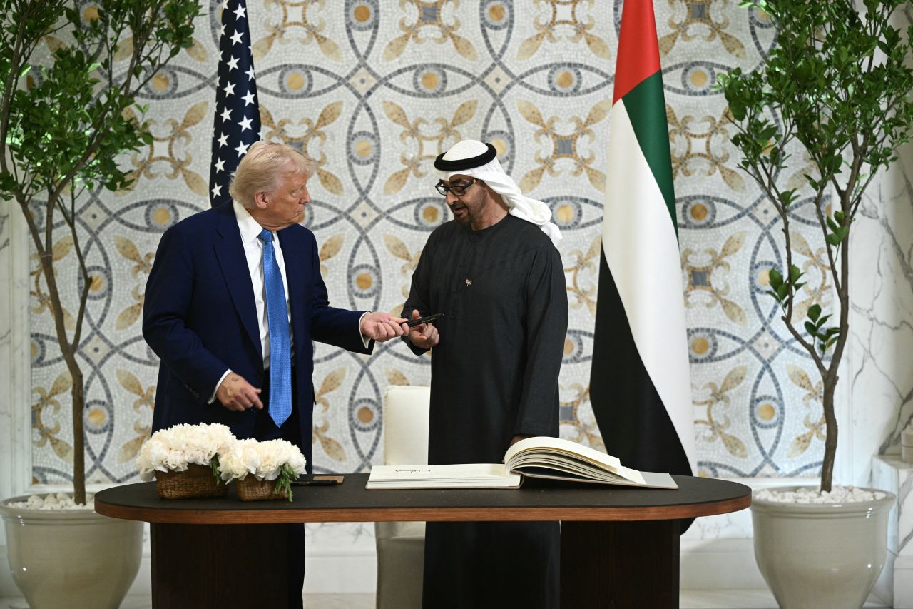 President Donald Trump returns the pen to his UAE counterpart Sheikh Mohamed bin Zayed Al Nahyan, after signing the guest book at Qasr Al-Watan in Abu Dhabi on Thursday.