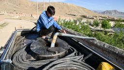 An Afghan boy fills his potable water tanker from a pump on the outskirts of Kabul on April 27, 2025.