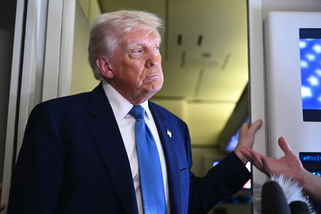 President Donald Trump speaks to members of the media aboard Air Force One, after leaving Abu Dhabi, United Arab Emirates, on Friday.