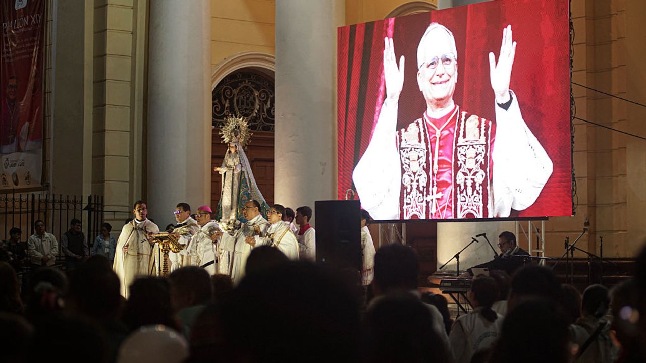 People participate in a vigil before a Holy Mass for the beginning of the Pontificate of Pope Leo XIV, in front of the Cathedral of Saint Mary in Chiclayo, Peru early on May 18, 2025. Ten days after the soft-spoken Robert Francis Prevost was chosen from among his fellow cardinals to lead the world's 1.4 billion Catholics, his papacy will formally begin in a ceremony at St Peter's Square. (Photo by Diego TORRES / AFP) (Photo by DIEGO TORRES/AFP via Getty Images)          