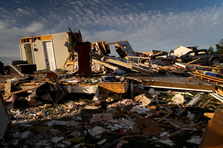 Debris is piled up from a destroyed house in the community of Sunshine Hills outside of London, Kentucky, on Sunday.
