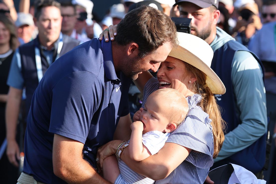Scheffler embraces his wife, Meredith, and his son after securing his third career major win.