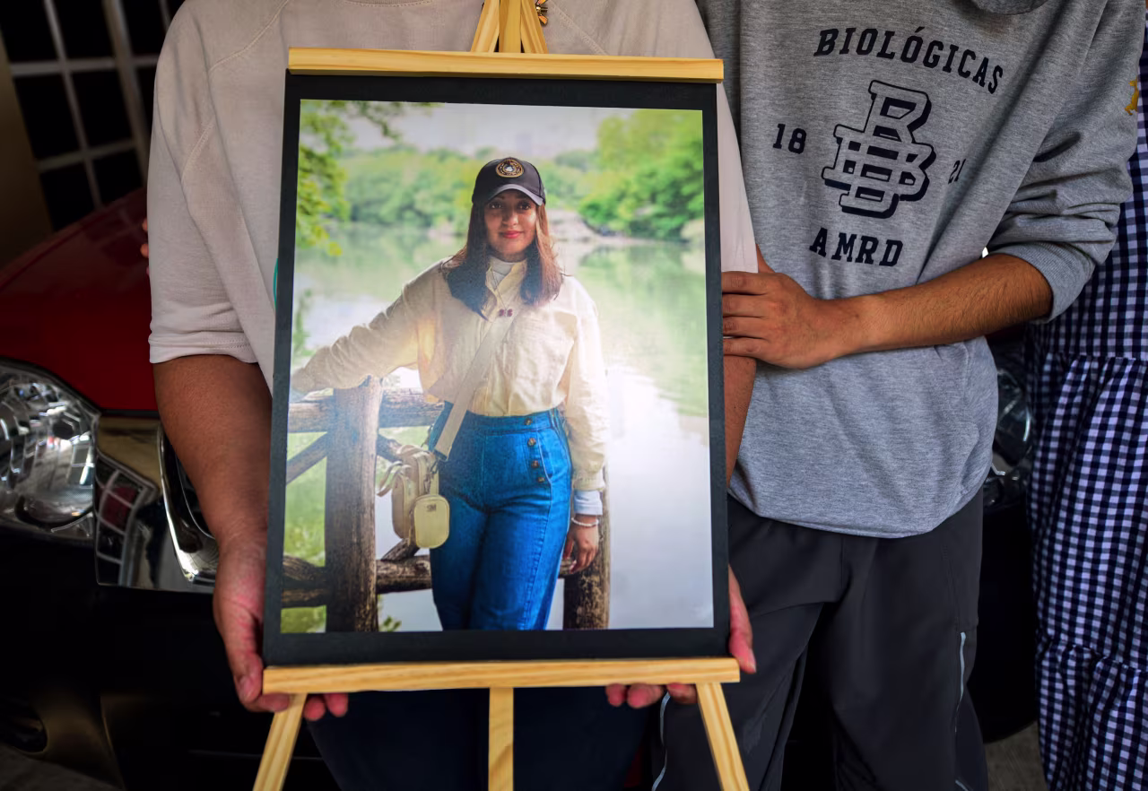 Relatives of América Yamilet Sánchez hold a portrait of her in Xalapa, Veracruz state, Mexico, on Sunday.
