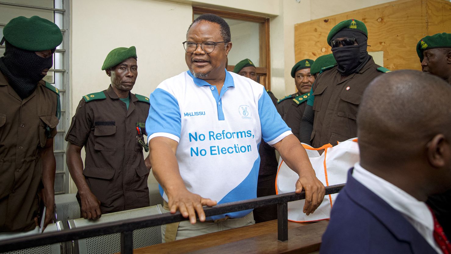 Tanzania's main opposition leader Tundu Lissu, center, stands in the dock at Kisutu magistrate's court in Dar es Salaam on May 19, 2025.