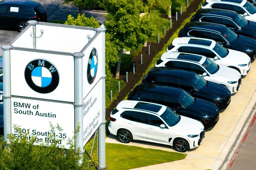BMW vehicles are displayed for sale at the BMW dealership in Texas. Car prices, even for many import models, have largely stayed unchanged despite tariffs raising the costs for automakers.