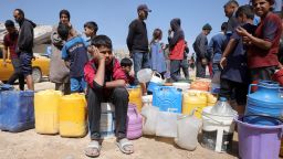 Palestinians attempt to collect water at a camp for displaced people in Gaza City, on May 20, 2025 amid Israel's military operation in the enclave.