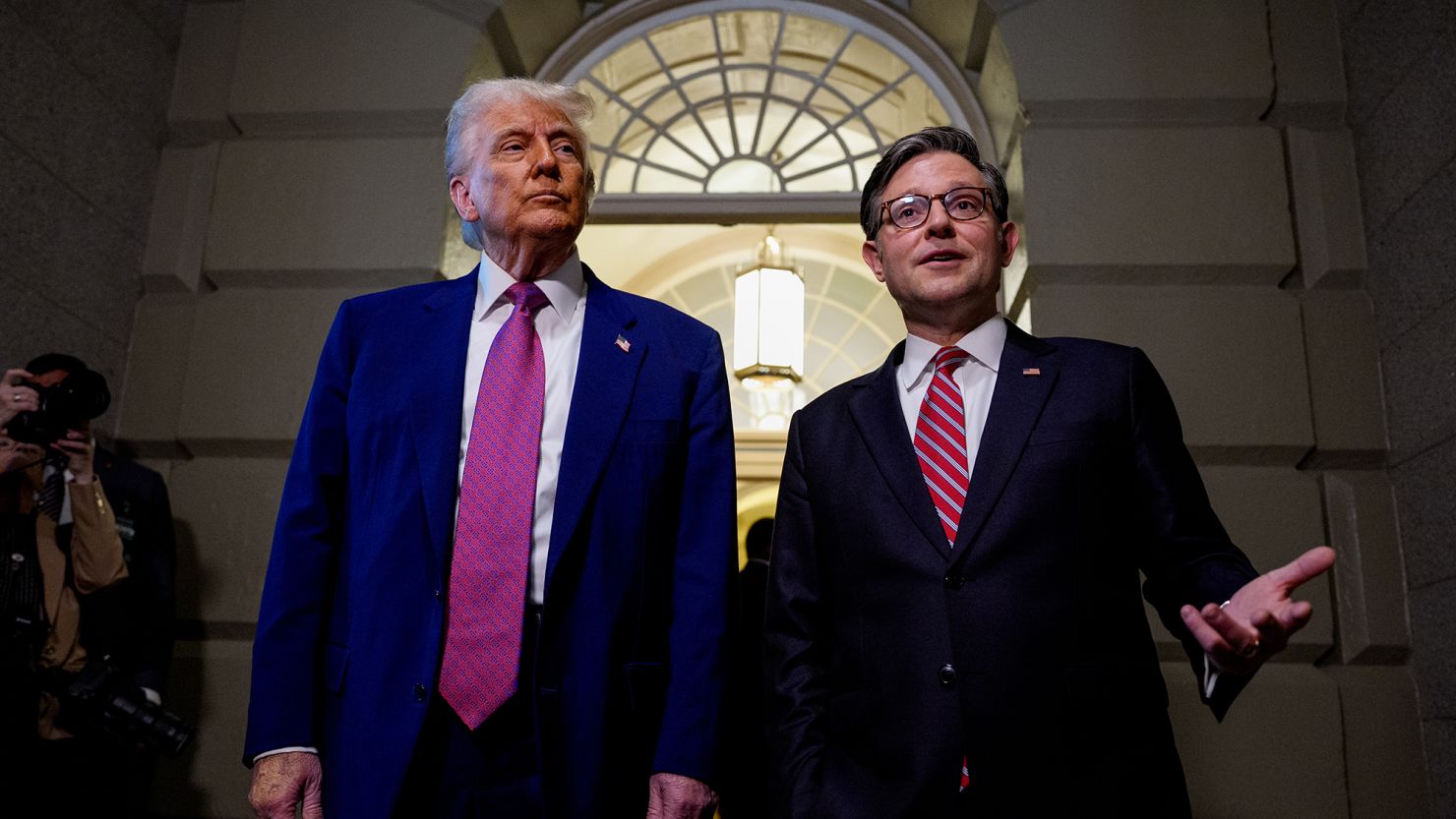 Speaker of the House Mike Johnson, accompanied by President Donald Trump.