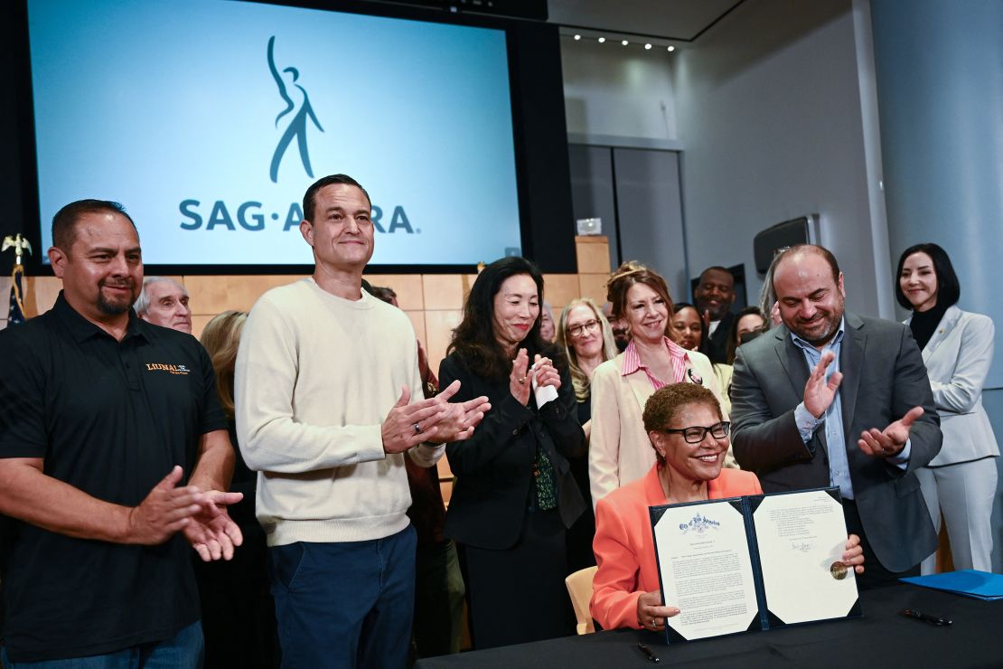 Los Angeles Mayor Karen Bass holds up a signed executive directive announcing support for filming and production jobs.