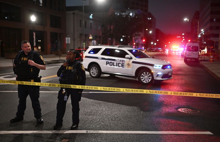 FBI agents cordon off the scene outside the Capital Jewish Museum following a shooting that left two people dead, in Washington, DC, in the early hours of May 22, 2025.