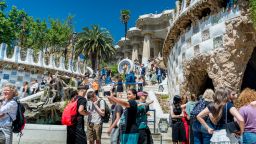2025/05/21: Tourists are seen taking pictures at the Parc Guell terrace, a famous tourist landmark. With more than 100 million tourists expected to visit Spain in 2025, and 18 million Barcelona alone, the city is struggling to find a balance between the economic benefits of mass tourism and the need to keep the city livable for local residents.