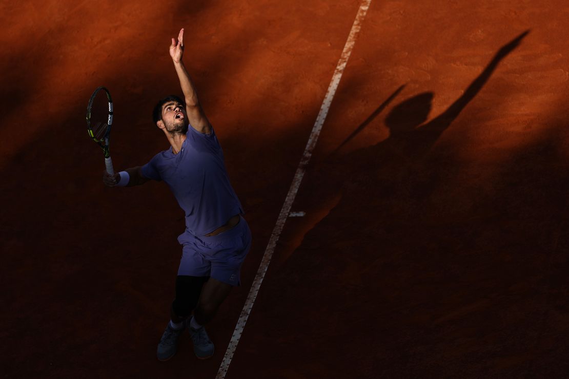 Alcaraz serves against Jannik Sinner in the final of the Italian Open.