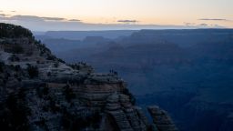 Tourists watch the sunset at Grand Canyon National Park in Grand Canyon, Arizona, US, on Tuesday, May 13, 2025. The new budget proposal from the US president would reduce the budget for the nation's national parks, monuments, historic sites, seashores and trails by nearly 25% and hand over many of those to the states, USA Today reports.